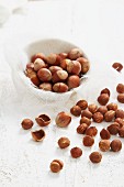 Hazelnuts in and out of shells with cracked shells
