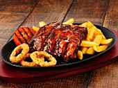 Glazed ribs with chips and onion rings