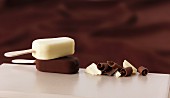 Milk chocolate-covered and white chocolate-covered ice cream sticks