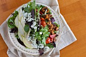 A salad with pears, nuts and blue cheese