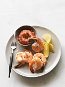 Prawns with cocktail sauce and lemons