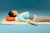 A relaxing position lying on the back to widen the chest