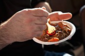 A man eating short ribs at Le Truc Bustaurant (Food Truck, San Francisco, USA)
