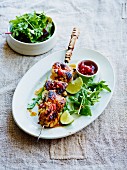 Lime chicken skewers with tomato and chilli chutney and a side salad