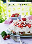 A strawberry cake with cream and white chocolate