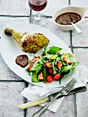 Chicken leg with a mustard crust served with strawberry salad