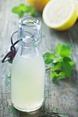 Lemonade in a flip-top bottle on green a wooden surface