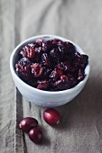 Dried cranberries in a bowl on a linen napkin