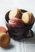 Macaroons in a brown tea cup