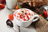 Cocoa with cream and strawberry sauce