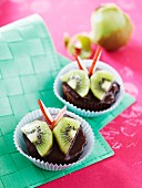 Chocolate muffins decorated with kiwi and apple 'butterflies'