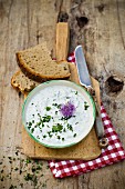 A herb dip with a chive flower
