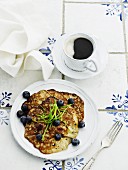 Blueberry pancakes and black coffee (seen from above)