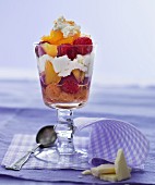 A layered dessert with fruits, sponge cake and white chocolate cream