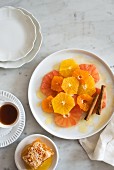 Citrus fruit salad with honey and cinnamon sticks