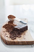 Dark chocolate and cocoa powder on a wooden chopping board