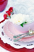 Pink place setting decorated with flowers & doilies