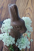 A chocolate bunny with a wreath of chervil