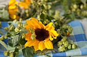 Sunflowers & hop tendrils on checked cloth