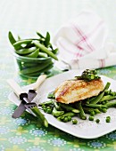 Chicken breast on a bed of green vegetables