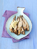 Smoked sprats with lemon