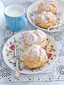 Profiteroles with whipped cream and icing sugar