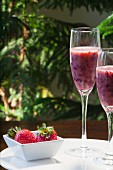 Blueberry and strawberry smoothies in stemmed glasses
