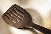 A spatula in a stainless steel pan