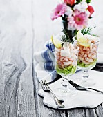 Two glasses of prawn cocktail on salad