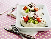 Mini pavlovas with kiwis, strawberries, cream and berry ice cream