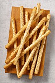 Sesame seed grissini on a wooden board