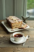 A cup of Earl Grey tea and pear cake with candied ginger and chocolate