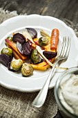 Oven-roasted vegetables on a plate with a fork