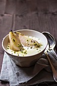 Poached pears with pistachios in vanilla cream