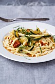Strozzapreti with a tomato and courgette medley and rosemary