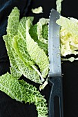 Sliced savoy cabbage with a knife