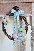 Hand-crafted willow wreath decorated with colourful eggs & ribbon