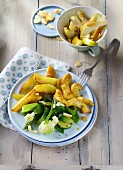 Curried chicken with green vegetables and potato wedges