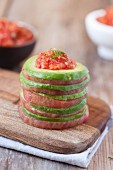 A tomato and avocado towers with a spicy chilli sauce