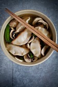 Miso soup with ginger, mange tout, spring onions, mushrooms and gyoza (Japan)