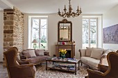 Sofa set and armchairs in comfortable lounge area in various shades of brown in traditional interior