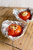 Stuffed grilled tomatoes with feta cheese in tin foil