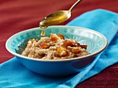 Sweet cracked wheat porridge with honey and dates