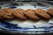 A row of ginger biscuits on a plate