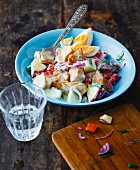 Colourful chicken salad with apple, peppers and onions
