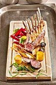 A rack of lamb with vegetables and rosemary