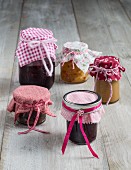 Colourful fabric lid covers for jars of preserves as gifts