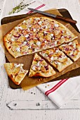 Tarte flambée with pear, red onion and goat's cheese