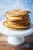 A stack of gluten-free pancakes with maple syrup