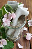 Silver spoon, linen napkin and quince flower in preserving jar
